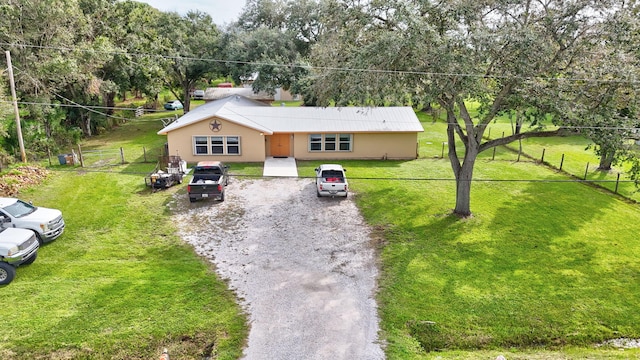 single story home featuring a front lawn