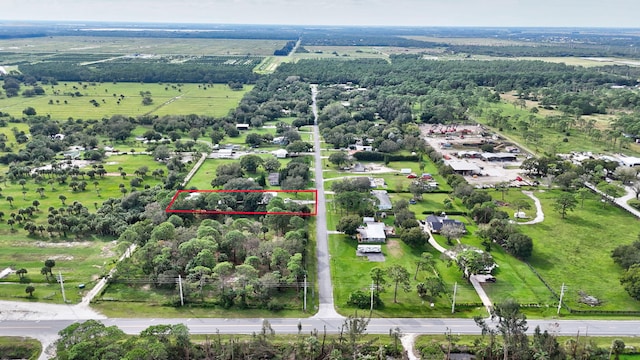 birds eye view of property with a rural view