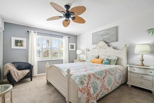 bedroom featuring light carpet, a textured ceiling, and ceiling fan