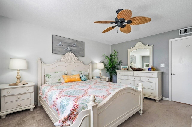 bedroom featuring a textured ceiling, carpet, and ceiling fan