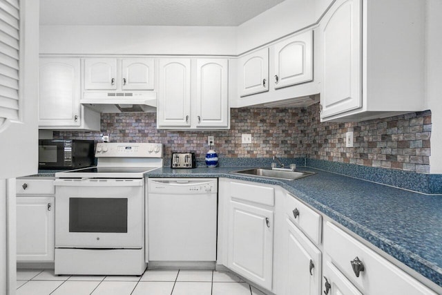 kitchen featuring light tile patterned floors, backsplash, white cabinetry, sink, and white appliances