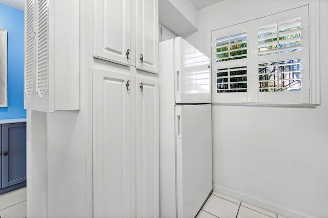 interior details with tile patterned flooring and white refrigerator