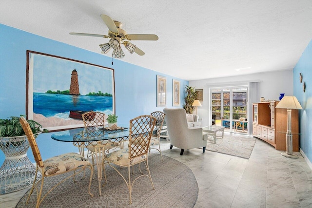 dining room with a textured ceiling and ceiling fan