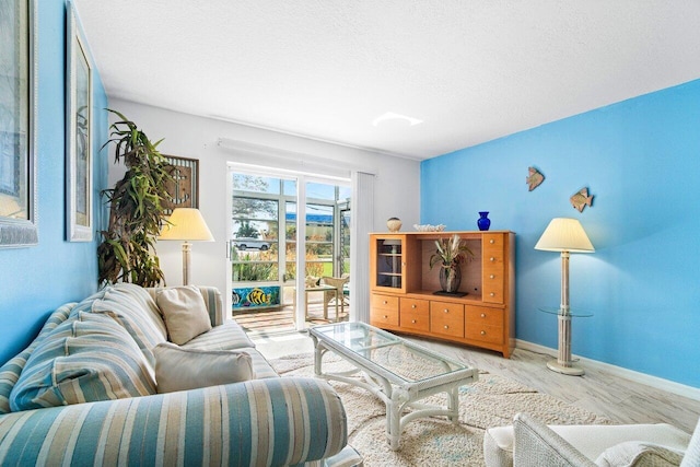 living room featuring a textured ceiling and light wood-type flooring