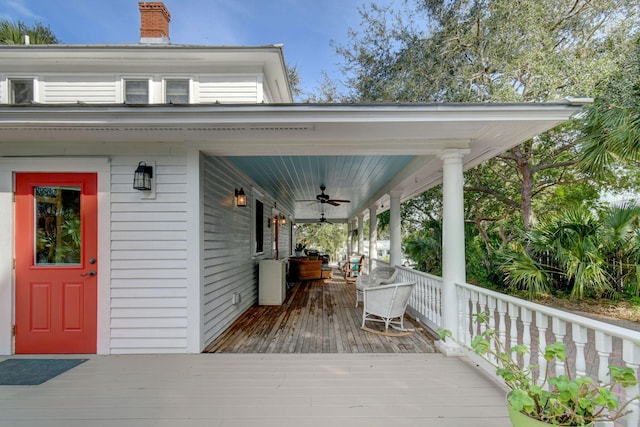 wooden deck featuring ceiling fan and covered porch