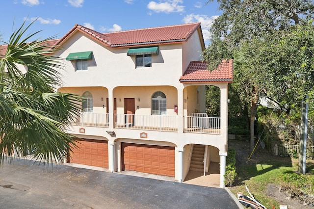 mediterranean / spanish house with a garage