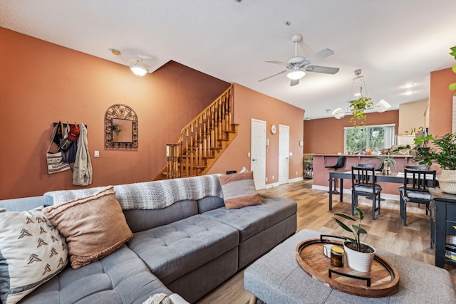 living room featuring light hardwood / wood-style flooring and ceiling fan