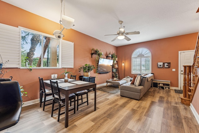 dining room with hardwood / wood-style flooring and ceiling fan