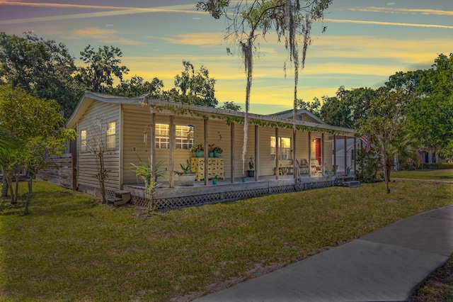 view of front of property with a yard and covered porch