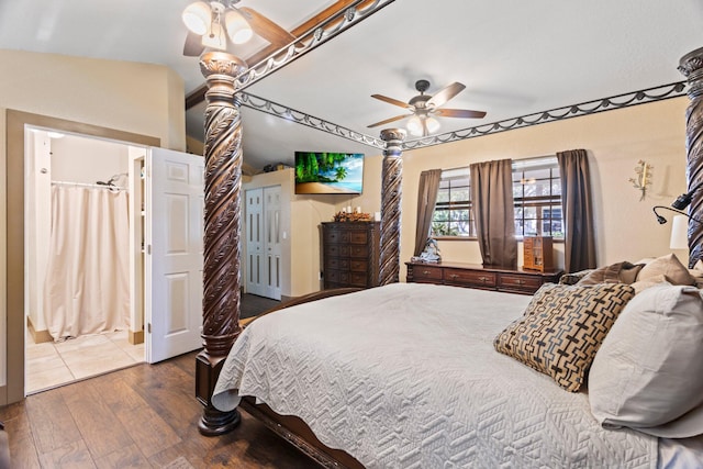 bedroom featuring ensuite bath, wood-type flooring, lofted ceiling, and ceiling fan