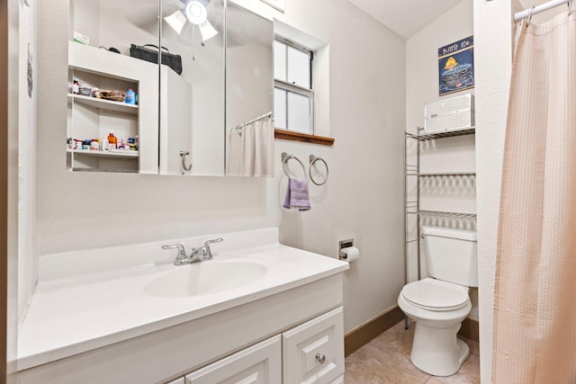 bathroom featuring vanity, toilet, and tile patterned flooring