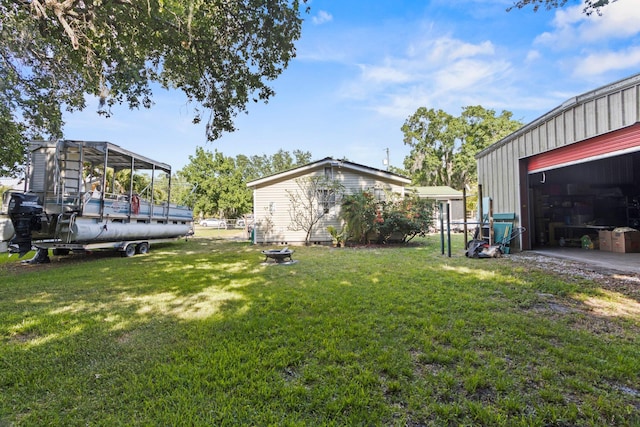 view of yard with an outbuilding and a garage