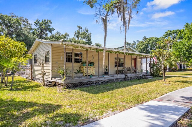 view of front of home with a front lawn and a porch