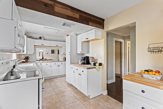 kitchen with white cabinetry, wooden counters, tasteful backsplash, and white appliances