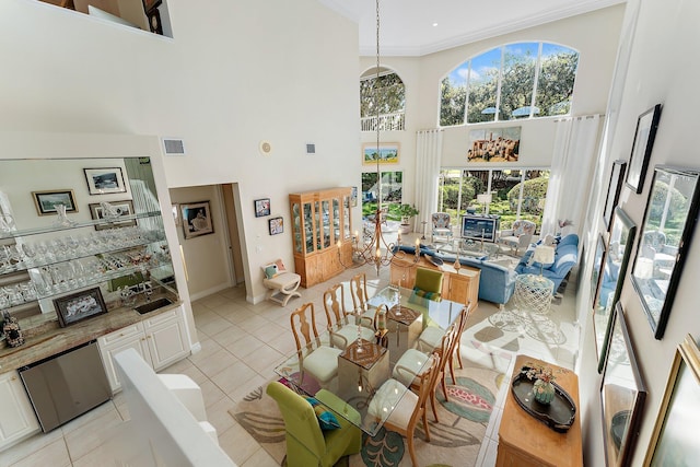 dining room with a high ceiling and light tile patterned floors