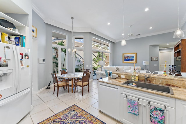 12020 SE Birkdale Run, Jupiter, FL 33469 - kitchen with a sink, white cabinetry, white appliances, and ornamental molding