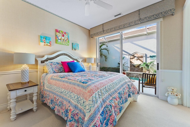 carpeted bedroom featuring access to outside, multiple windows, and ceiling fan