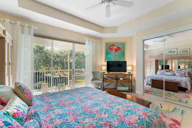 bedroom featuring access to outside, a closet, hardwood / wood-style flooring, and ceiling fan