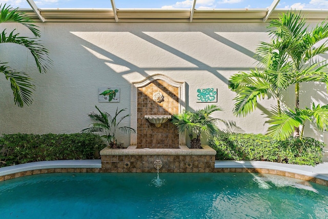 view of swimming pool featuring pool water feature