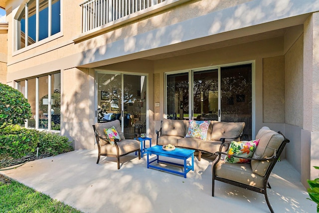 view of patio with a balcony and an outdoor hangout area