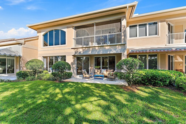 12020 SE Birkdale Run, Jupiter, FL 33469 - rear view of house with a balcony, a patio, stucco siding, an outdoor hangout area, and a lawn