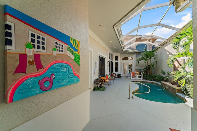 view of pool featuring pool water feature, a patio area, and a lanai