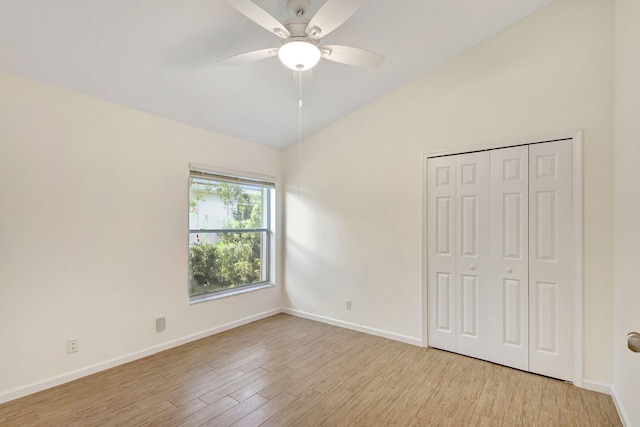 unfurnished bedroom with ceiling fan, a closet, and light wood-type flooring