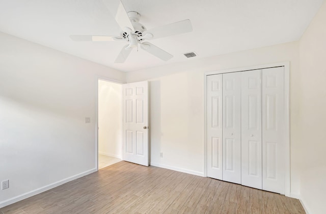 unfurnished bedroom featuring ceiling fan, a closet, and light hardwood / wood-style flooring