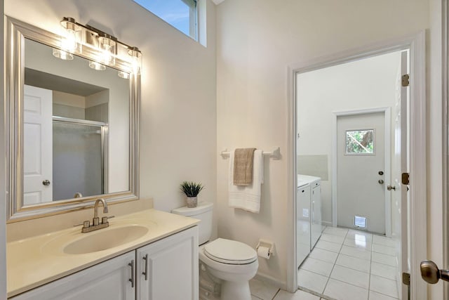 bathroom featuring walk in shower, vanity, washer and dryer, tile patterned floors, and toilet