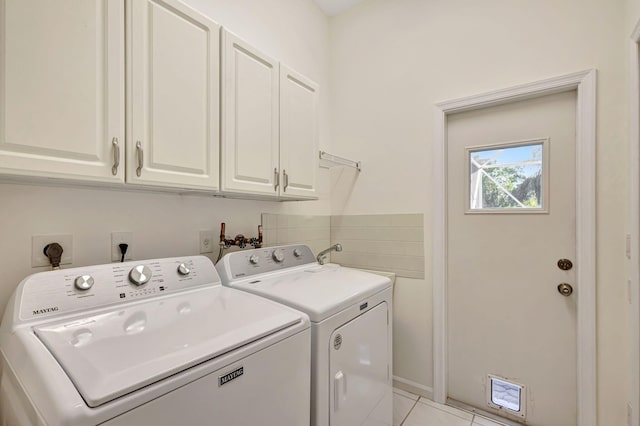 6481 Spartina Cir, Jupiter, FL 33458 - laundry area with cabinet space, washing machine and dryer, and light tile patterned floors