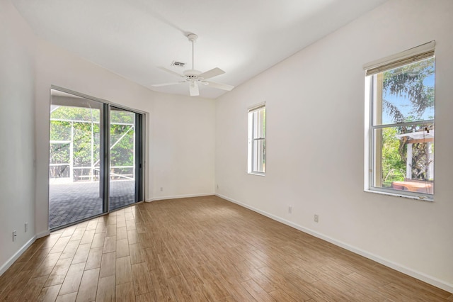 empty room with light hardwood / wood-style flooring, ceiling fan, and plenty of natural light