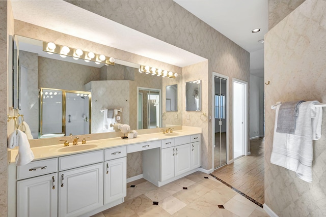 bathroom featuring walk in shower, vanity, and hardwood / wood-style flooring