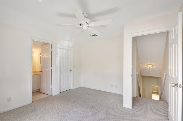 unfurnished bedroom with ensuite bath, ceiling fan, and light colored carpet