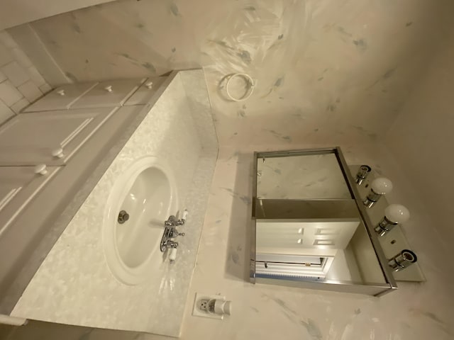 bathroom featuring vanity and backsplash