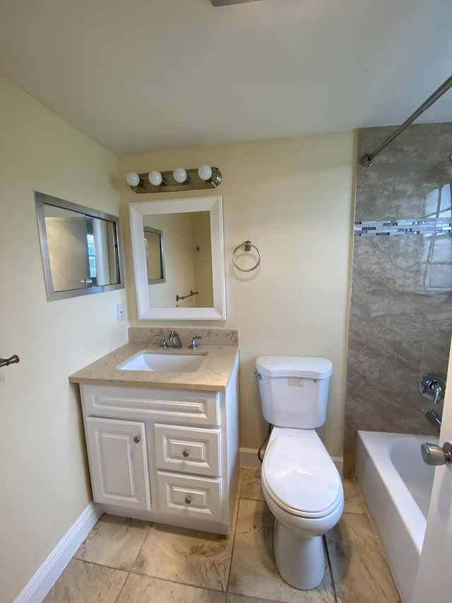 full bathroom featuring tiled shower / bath, vanity, and toilet