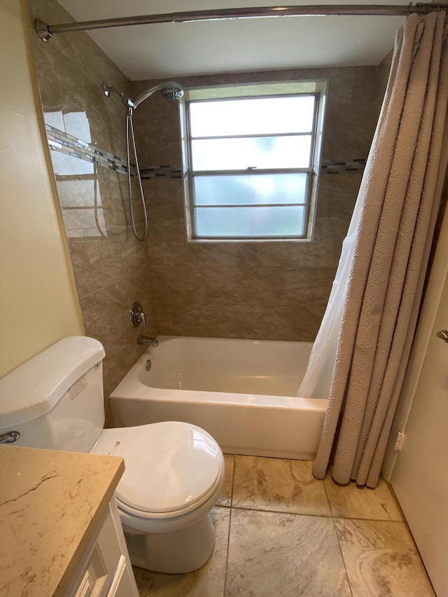 full bathroom featuring tile patterned floors, shower / bath combo with shower curtain, vanity, and toilet