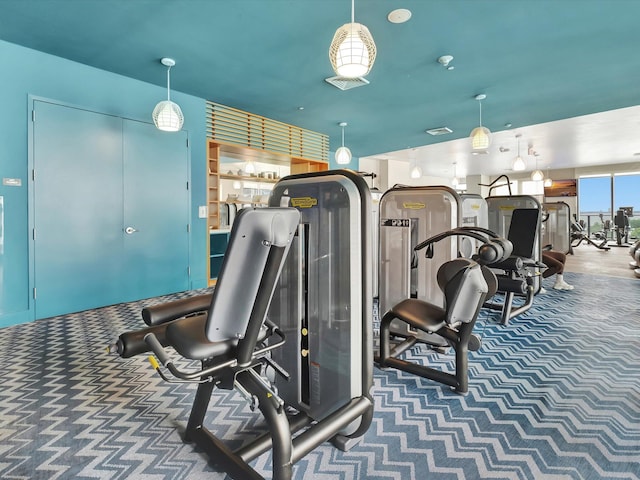 workout area featuring dark colored carpet