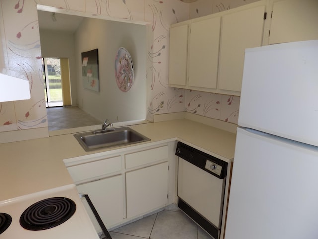 kitchen with sink, white cabinetry, white appliances, and light tile patterned floors