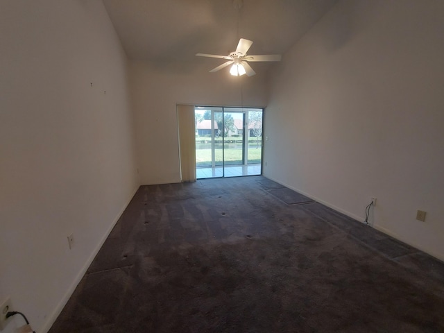 carpeted empty room with high vaulted ceiling and ceiling fan