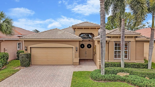 mediterranean / spanish-style house with a garage