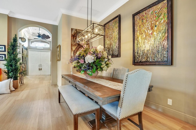 dining area featuring crown molding, hardwood / wood-style floors, and ceiling fan with notable chandelier