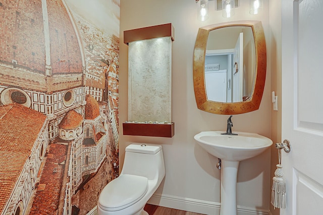 bathroom with sink, hardwood / wood-style floors, and toilet