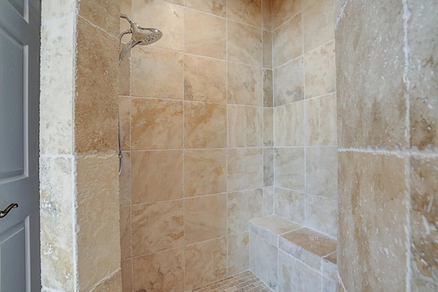 interior details with a tile shower