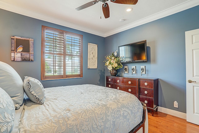 bedroom featuring ceiling fan, light hardwood / wood-style floors, and ornamental molding