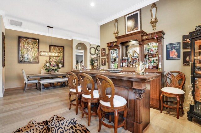 kitchen with a center island, sink, hanging light fixtures, stainless steel appliances, and a breakfast bar