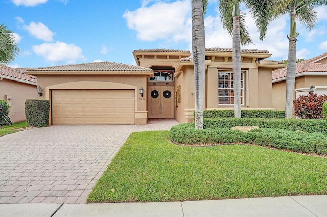 mediterranean / spanish-style home with a front yard and a garage