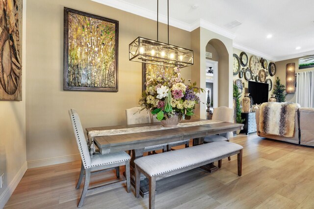 kitchen with an inviting chandelier, sink, hanging light fixtures, light stone countertops, and light wood-type flooring