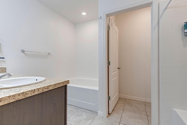 bathroom featuring tile patterned floors, vanity, and a washtub