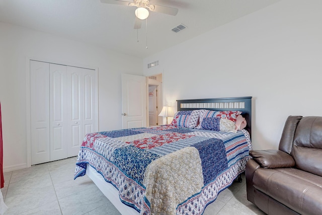 tiled bedroom featuring ceiling fan and a closet