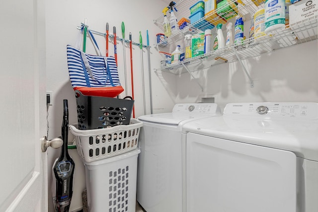 clothes washing area with washer and clothes dryer